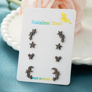 Set of 4 pairs black stainless steel star and moon stud earrings on display card