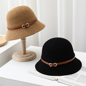 Detail of knitted bucket hats featuring leather belt trim and gold metal buckles