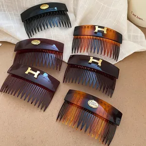Retro acrylic oval hair comb clips in amber and black with vintage gold letter buckle