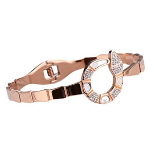 Elegant rose gold snake bangle with white shell inlay and sparkling crystals on white background