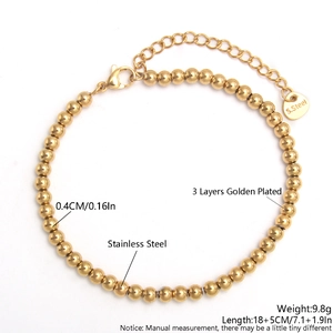 Detail of 4mm golden stainless steel beaded bracelet with lobster clasp and extension chain