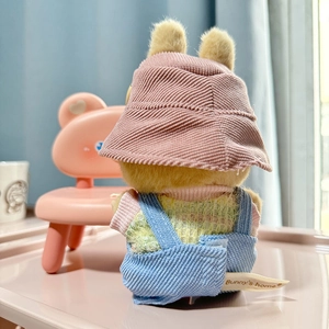 Rear view of Labubu doll wearing a pink corduroy bucket hat and blue denim overalls