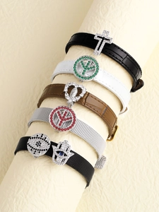 Close-up of leather and mesh bracelets with zirconia religious and evil eye charms