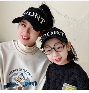 Close-up of black sport visor hats with white embroidery for adults and children