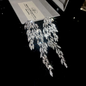 Macro detail of silver-tone tassel earrings featuring marquise-cut marquise-cut leaf zircons