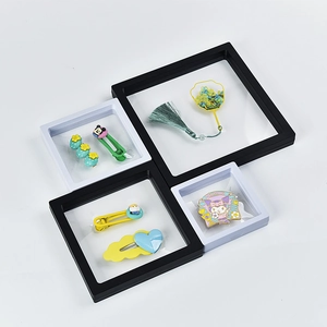 Macro detail of various sized 3D floating display frames for jewelry storage in black and white