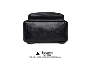 Detailed bottom view of the black lychee pattern leather backpack showing wide base texture