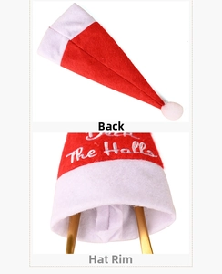 Detail view of Deck The Halls embroidery and inner lining of a plush Christmas hat
