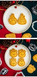 Close-up of mini cartoon Christmas cookies and animal-shaped baking molds on festive background