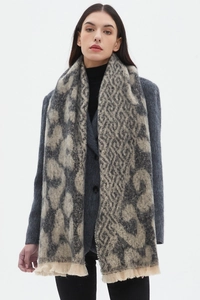 Detailed view of beige and gray geometric woven scarf with elegant fringe tassels