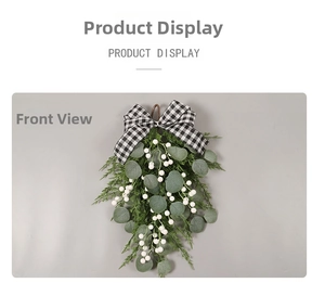 Detail of Christmas eucalyptus teardrop swag with white berries and plaid bow knot
