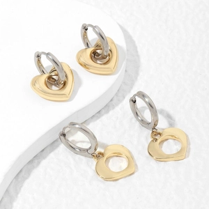 Minimalist silver hoop earrings with mixed gold heart pendants in polished finish