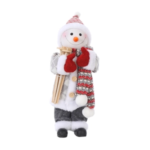 Detail of Christmas snowman figurine with red knit hat, scarf and wooden skis
