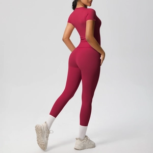Close-up of red two-piece workout set showing high-waist yoga pants and tight top