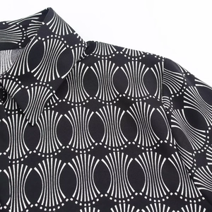 Detail of the geometric pattern and classic collar on a black and white women's shirt
