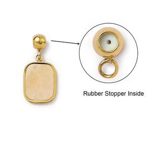 Detail of gold pendant connector with yellow stone and internal rubber stopper feature