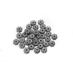 Macro shot of silver flower-shaped CCB spacer beads for DIY jewelry making