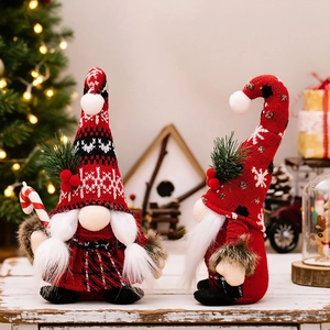 Detail of Christmas faceless gnomes with knitted hats and candy canes on wood