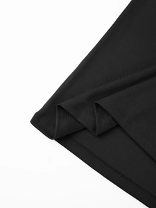 Detailed close-up of double-stitched hem and breathable mesh fabric on black polo shirt