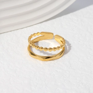 Detail of a gold double-layered adjustable ring with beaded and geometric patterns