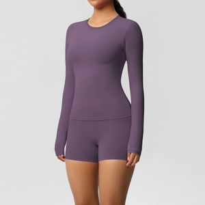 Front view of deep purple long-sleeve top and high-waist yoga shorts on a fitness model