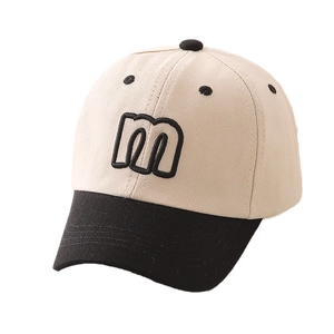 Detailed close-up of cotton twill fabric and black letter m embroidery on baseball cap