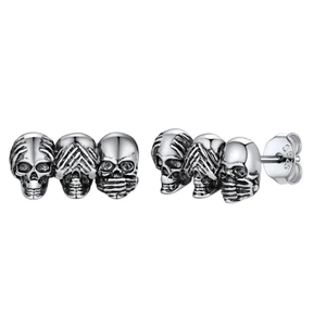 Macro detail of triple skull stud earrings in retro silver with S925 hallmark