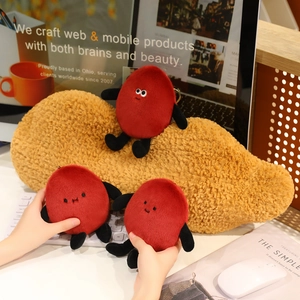 Macro detail of funny red peanut plush pendants with cute expressions on an office desk