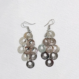 Detail of bohemian layered silver circular earrings with concentric textured metal discs