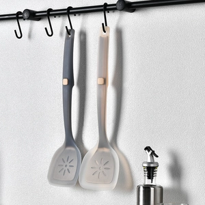 Hanging silicone spatulas in grey and beige with floral cutouts for non-stick pans