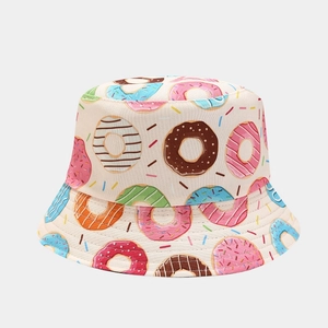 Detail showing high-quality colorful donut pattern on a beige cotton bucket hat fabric