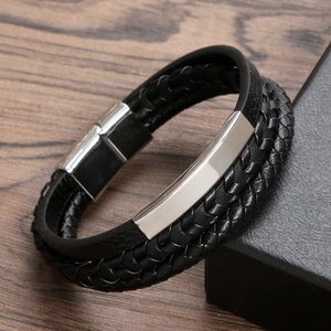 Men's multilayer black braided leather bracelet with silver metal magnetic clasp on wood