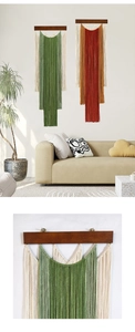 Detailed view of hand-woven bohemian tapestry with layered tassels and natural wood rod