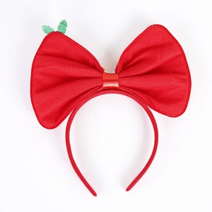 Christmas headband with oversized red sequin bow and green holly leaf on white background