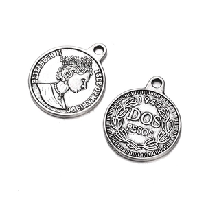 Macro view showing both sides of vintage silver coin pendants with Queen Elizabeth profile