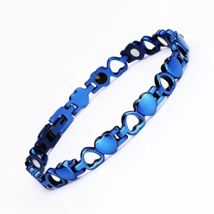 Macro shot of blue heart-shaped metal magnetic therapy bracelet with polished links
