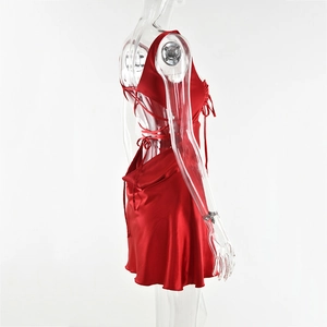 Detail view of the red satin mini dress featuring backless crisscross lace-up design