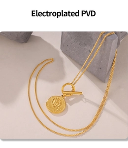 Detail of 18k gold PVD plated coin pendant and OT toggle clasp on irregular chain