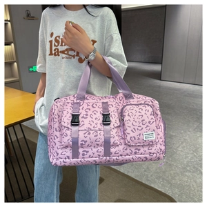 Detailed shot of pink leopard print fitness bag showing buckle and zipper pockets