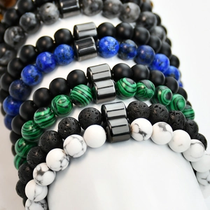Macro view of stacked beaded bracelets in malachite lava stone and lapis lazuli texture