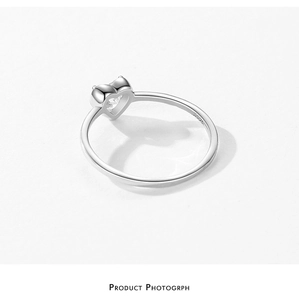 Macro detail of S925 sterling silver ring showing heart-shaped zircon and hallmark