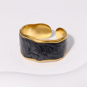 Minimalist wide open stainless steel ring with golden irregular edges and black oil texture