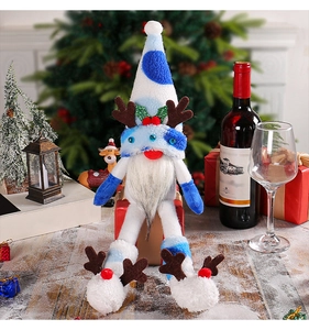 Detail of plush Christmas gnome with reindeer antlers and long legs in blue and white