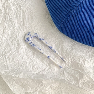Macro detail of the smooth blue marble texture on this acetate U-shaped hair fork