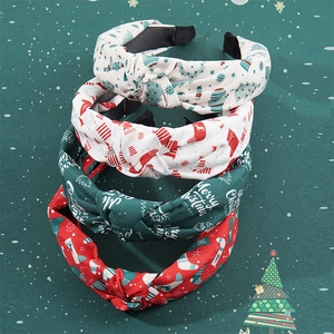 Set of four Christmas knot headbands with festive prints on holiday background