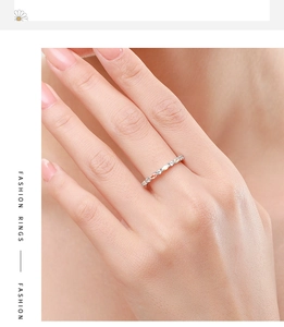 Close-up of s925 silver eternity ring with colorful marquise zircons on woman hand