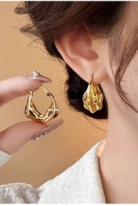 Detail of 18K gold plated V-shaped pleated earrings on model for a modern minimalist look
