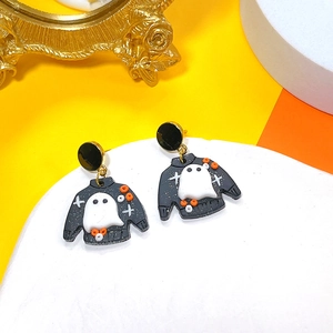 Detailed close-up of handmade Halloween clay earrings featuring cute ghost and sweater pattern