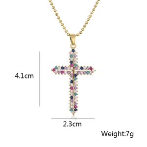 Macro shot of gold-plated cross pendant with dimensions 4.1x2.3cm and 7g weight