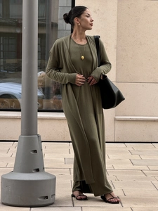 Detailed texture of olive green knit cardigan and matching dress set in outdoor setting
